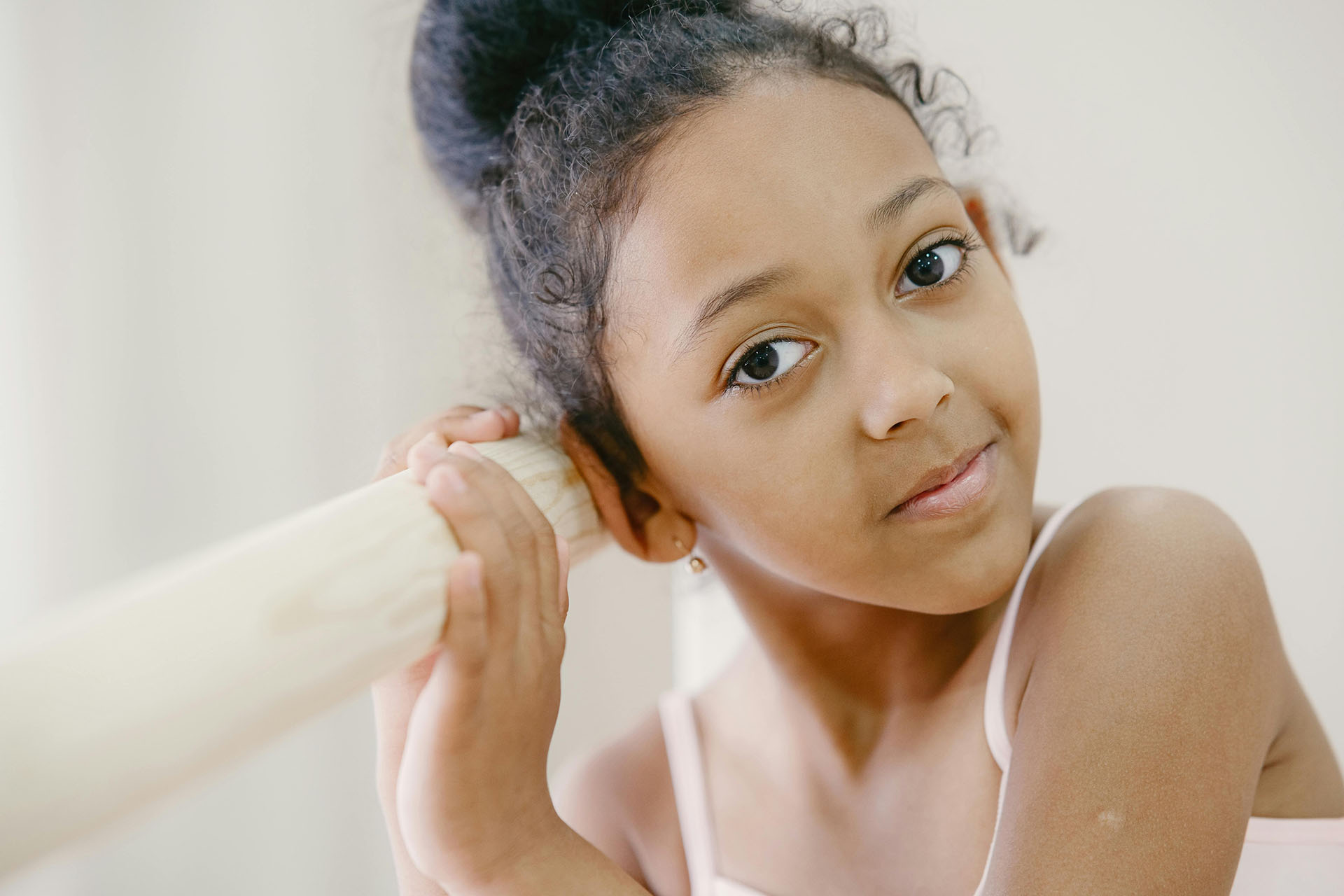Young girl at dance barre in Surrey BC representing local dance studio training and marketing community.