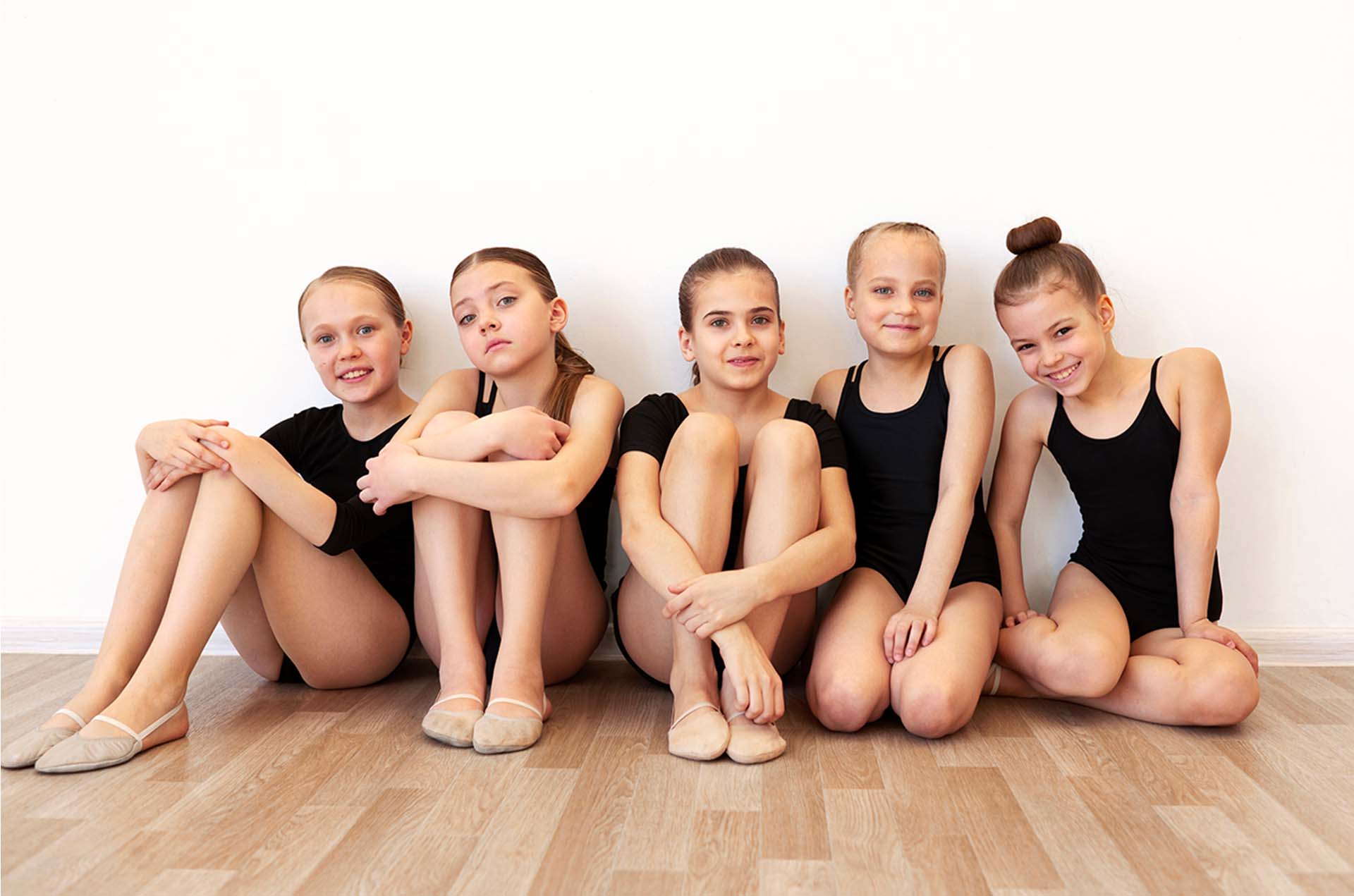 Group of kids laughing and connecting in a dance studio environment