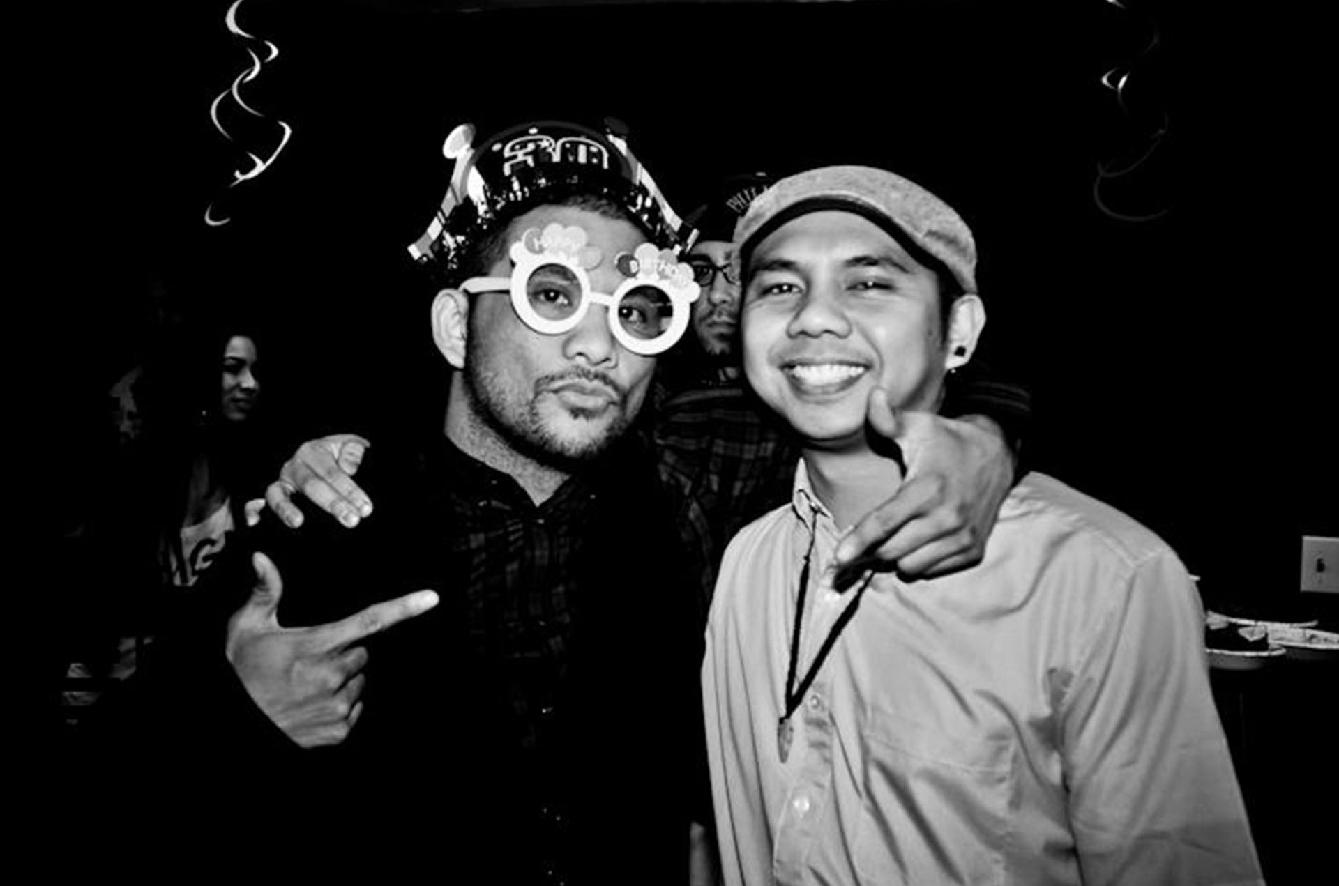 Marc and Stew posing together at a birthday celebration in black and white photo