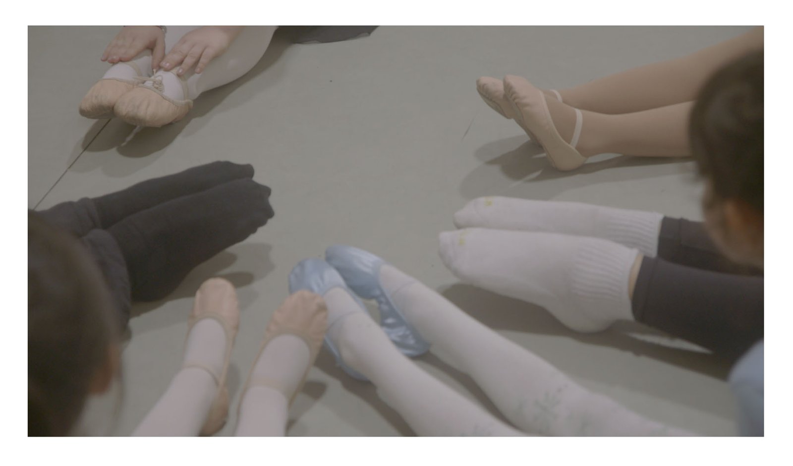 Ballet shoes and dance footwear arranged in a circle during a Dance Xpressions class