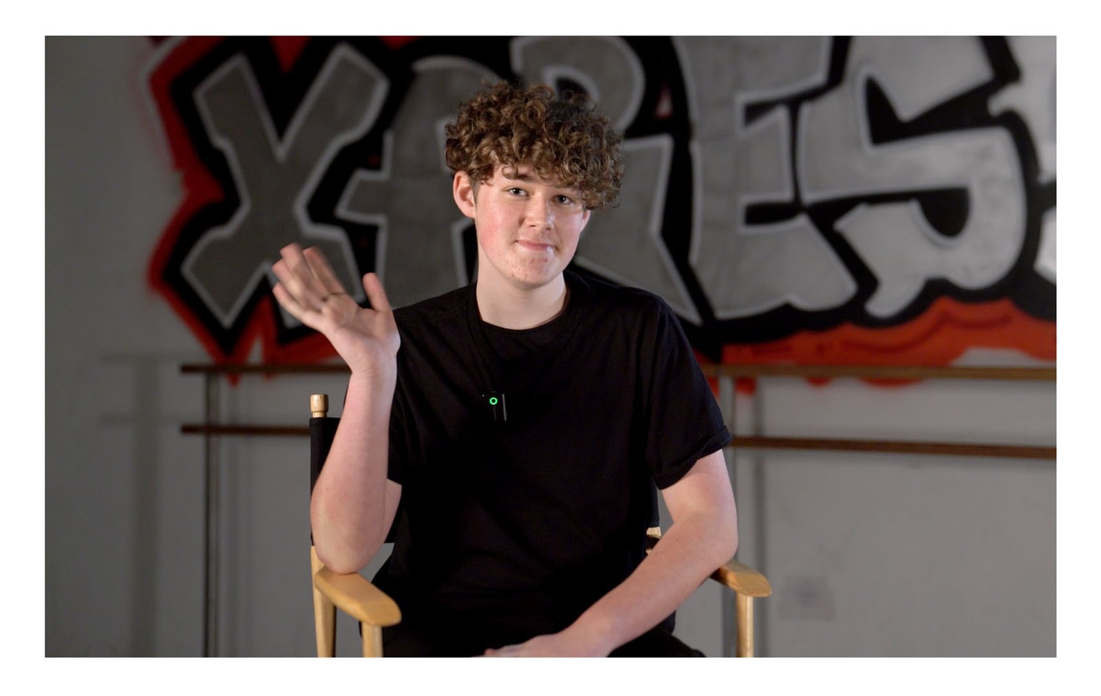 Dance Xpressions dancer waving during an on-camera Media Day interview