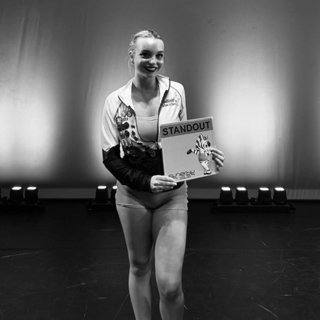 Mekyela Varnas holding her 2026 Caulfield School of Dance graduation quote on stage.